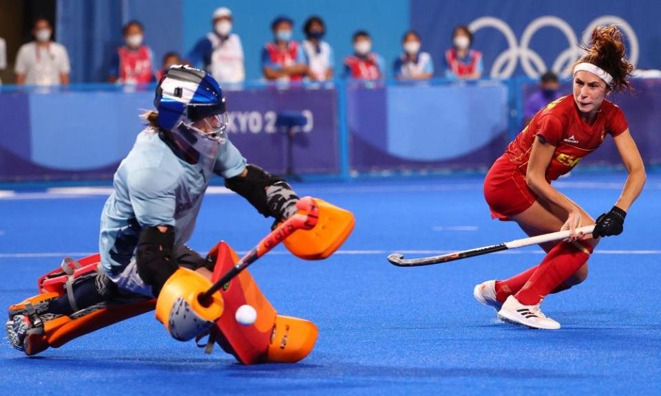 Maddie Hinch of Britain saves a shot by Begona Garcia of Spain during their shootout.