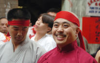 FILE - In this Aug. 6, 2006 file photo, Raymond "Shrimp Boy" Chow smiles after being sworn in as the "Dragon Head" of the Chee Kung Tong in Chinatown in San Francisco. Chow, a central figure in a sweeping San Francisco organized crime and public corruption case, pleaded not guilty. The FBI spent many millions of dollars and used more than a dozen undercover operatives posing as honest businessmen and Mafia figures alike during its seven year organized crime investigation centered in San Francisco’s Chinatown. Now, an increasing number of the defendants caught up in the probe that has ensnared a state senator and an aide are arguing that the FBI and its undercover agents are guilty of entrapment, luring otherwise honest people to go along with criminal schemes hatched by federal officials. (AP Photo/Sing Tao Daily, File)