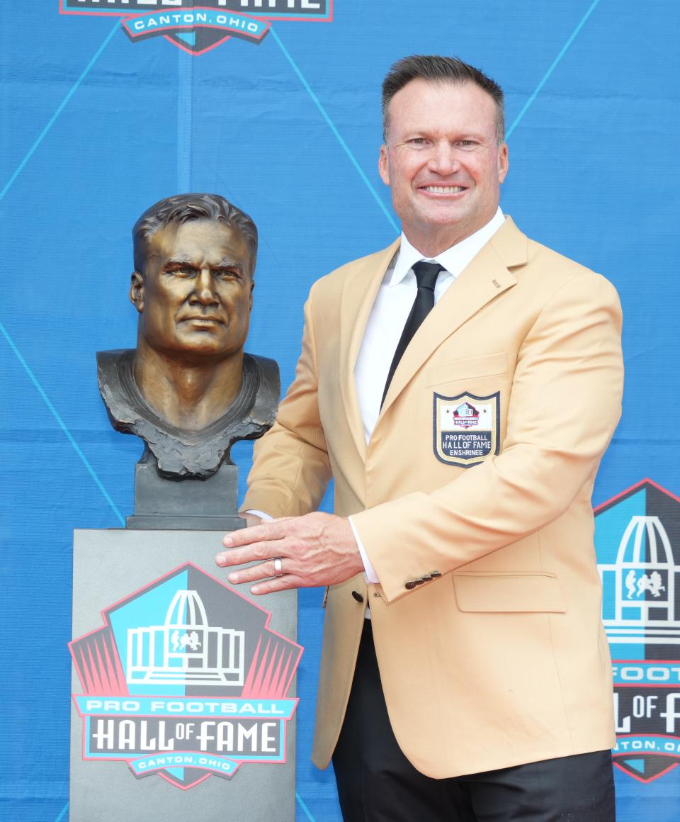 Former Texas Tech linebacker Zach Thomas poses with his bust during Saturday's Pro Football Hall of Fame enshrinement ceremonies in Canton, Ohio. Thomas was named first- or second-team All-Pro seven times during a 13-year NFL career spent mostly with the Miami Dolphins.