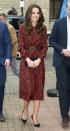 <p>The Duchess wears a Red floral dress by Vanessa Seward with a black belt, suede clutch and pointed-toe pumps in London.</p>