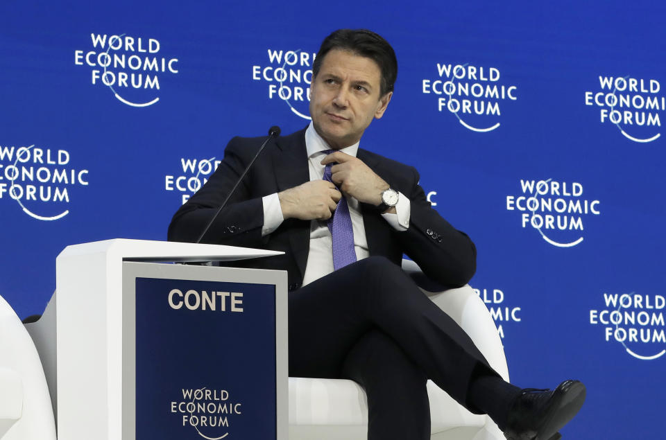 Italian Prime Minister Giuseppe Conte adjusts his tie before addressing the annual meeting of the World Economic Forum in Davos, Switzerland, Wednesday, Jan. 23, 2019. (AP Photo/Markus Schreiber)