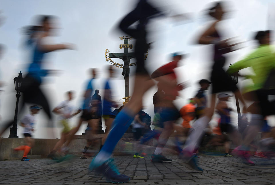 <p>Athletes cross the Charles Bridge as they compete in the Prague Marathon, May 7, 2017. (Michal Cizek/AFP/Getty Images) </p>