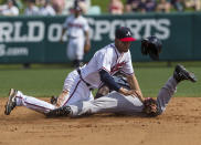 New York Yankees Melky Mesa (bottom) collides with Atlanta Braves shortstop Andrelton Simmons while attempting to steal second during the third inning of their MLB spring training game in Lake Buena Vista, Florida, February 23, 2013. REUTERS/Scott Audette (UNITED STATES - Tags: SPORT BASEBALL TPX IMAGES OF THE DAY) - RTR3E6G0