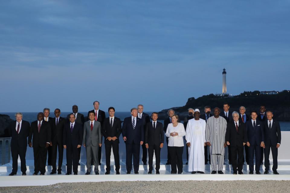 President Donald Trump poses with other G7 leaders and guests for a 