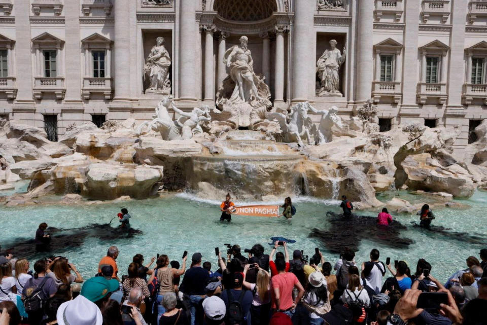 Climate activists pour vegetable charcoal in the Trevi Fountain water, during a demonstration against fossil fuels, in Rome, Italy May 21, 2023 in this image obtained from social media.  / Credit: ALESSANDRO PENSO/MAPS