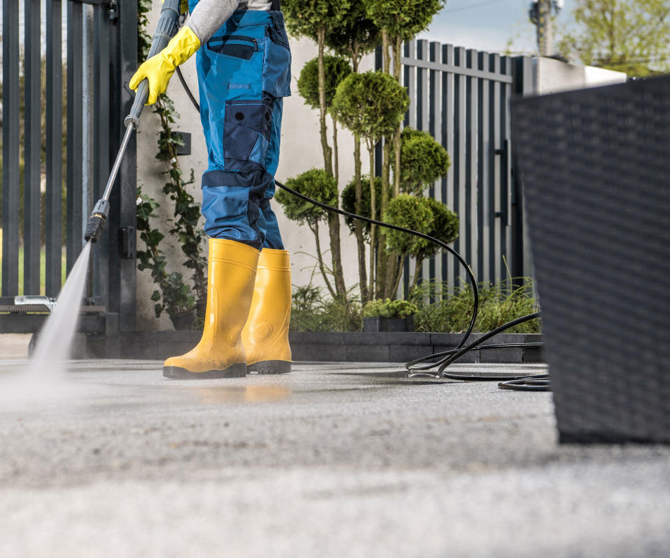 cleaning a patio with a pressure washer