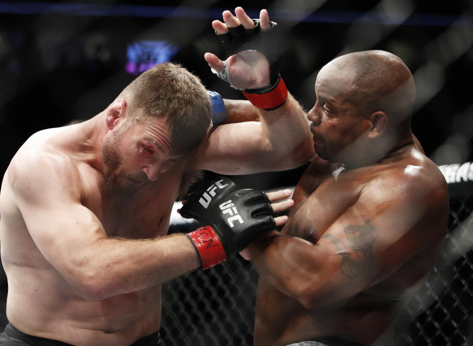 FILE - In this July 7, 2018, file photo, Daniel Cormier, right, fights Stipe Miocic during a heavyweight title mixed martial arts bout at UFC 226 in Las Vegas. The trilogy fight between Daniel Cormier and champ Stipe Miocic will crown the greatest heavyweight of all time. UFC 252 Saturday, Aug. 15, 2020, in Las Vegas could be Cormier's last fight ever. (AP Photo/John Locher, File)