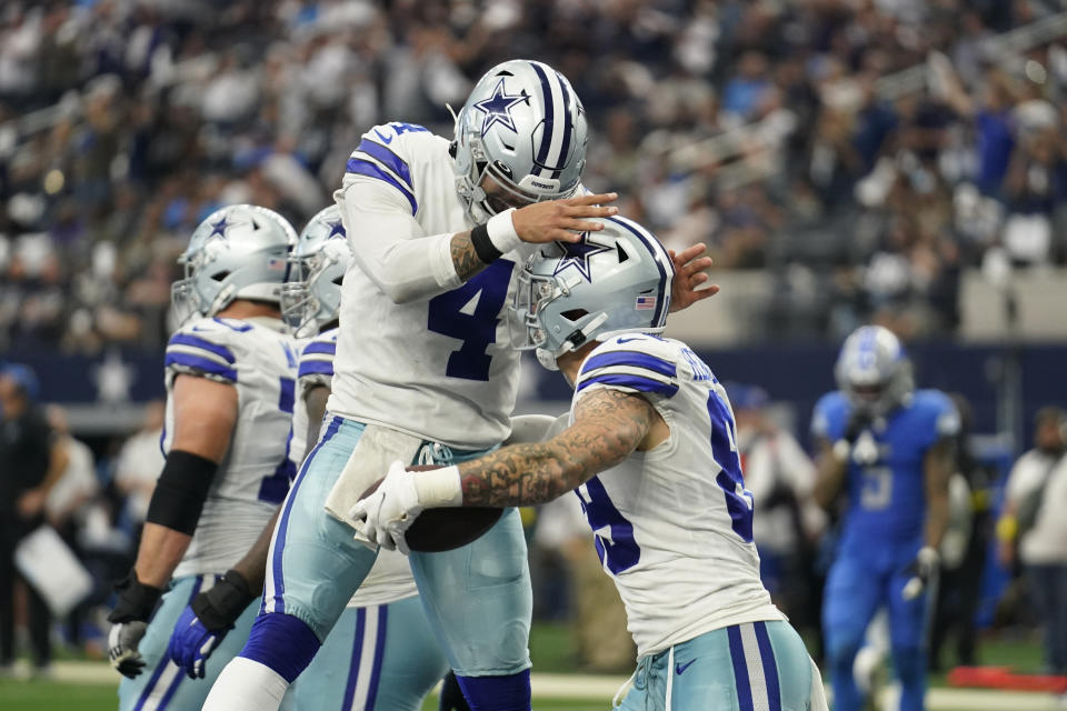 Dallas Cowboys quarterback Dak Prescott congratulates tight end Peyton Hendershot after his touchdown in the second half of an NFL football game against the Detroit Lions, Sunday, Oct. 23, 2022, in Arlington, Texas. (AP Photo/Tony Gutierrez)