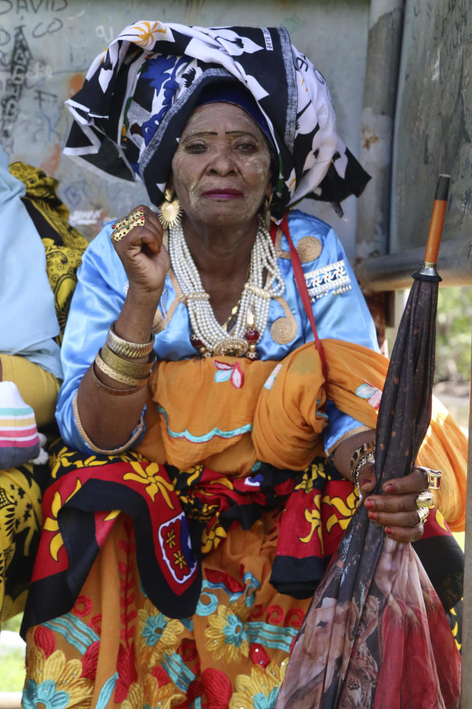 A woman supporting the so-called Wuambushu operation that aims at expelling migrants, attends a gathering at a soccer stadium in Chirongui, in the French Indian Ocean territory of Mayotte, Thursday, April 27, 2023. About a thousand people gathered in Chirongui. France is facing a migration quagmire on the island territory of Mayotte off Africa’s east coast. The government sent in 2,000 troops and police to carry out mass expulsions, destroy slums and eradicate violent gangs. But the operation has become bogged down and raised concerns of abuse, aggravating tensions between local residents and immigrants from the neighboring country of Comoros. (AP Photo/Gregoire Merot)