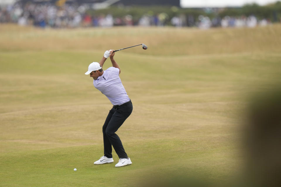 Scottie Scheffler of the US plays a shot onto the 5th green during the final round of the British Open golf championship on the Old Course at St. Andrews, Scotland, Sunday July 17, 2022. (AP Photo/Alastair Grant)