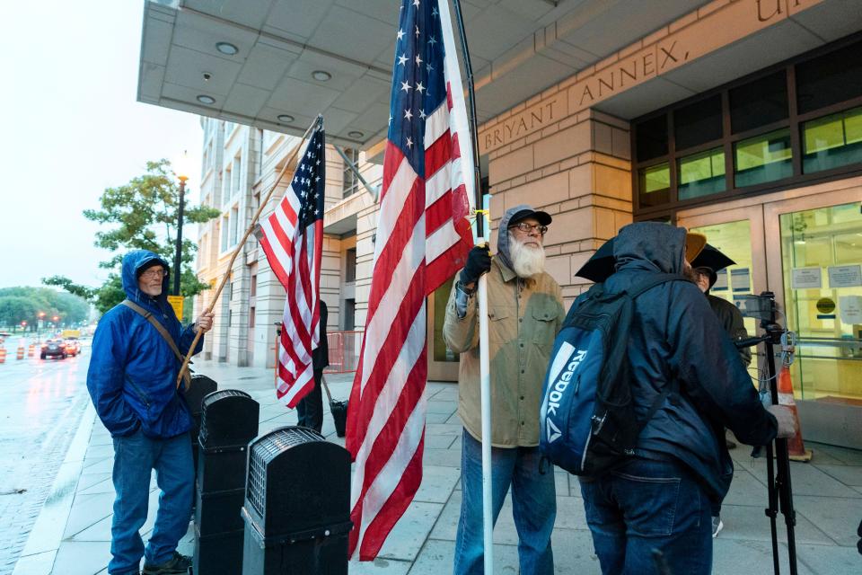 Supporters of the extremist group Oath Keepers stand outside the federal courthouse, on Monday, Oct. 3, 2022, in Washington.