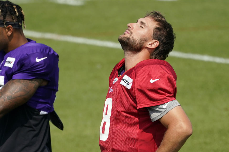 Minnesota Vikings quarterback Kirk Cousins (8) does neck stretch the NFL football team's training camp Monday Aug. 24, 2020, in Eagan, Minn. (AP Photo/Jim Mone)