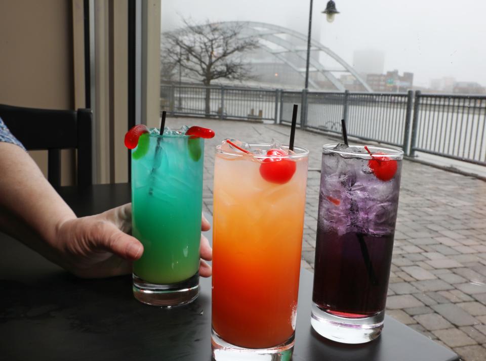 A trio of solar eclipse themed drinks, the Alien, the Eclipse and the Black Hole, at the newly opened Rabbit Hole Tavern. The Frederick Douglass-Susan B. Anthony Memorial Bridge can be seen out the windows, spanning the Genesee River.