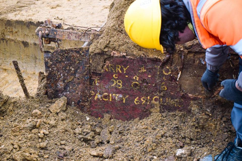 A close-up view shows the text on the old wooden train car.