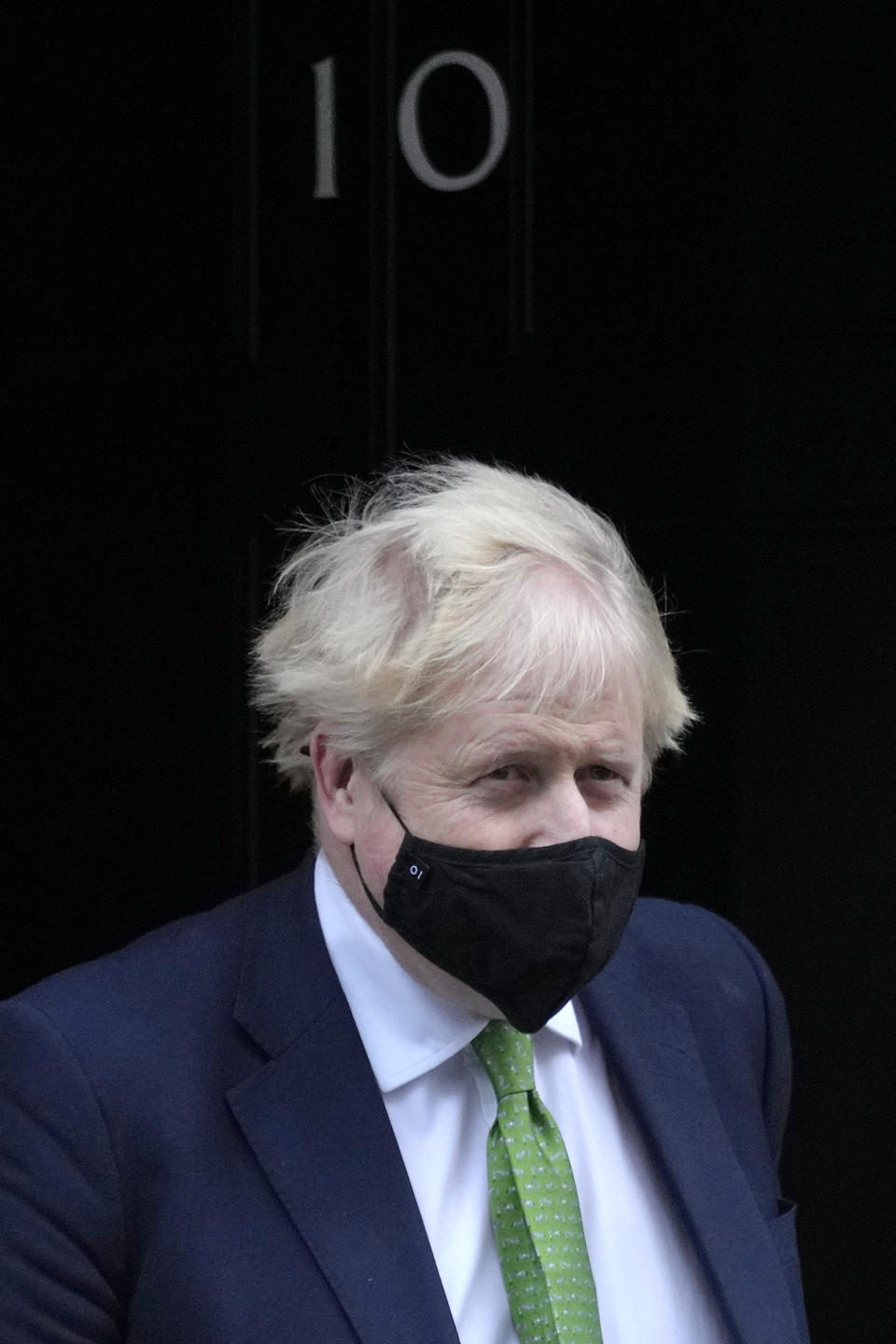 Britain's Prime Minister Boris Johnson leaves 10 Downing Street to attend the weekly session of Prime Minister's Questions in Parliament in London, Wednesday, Jan. 19, 2022. (AP Photo/Kirsty Wigglesworth)