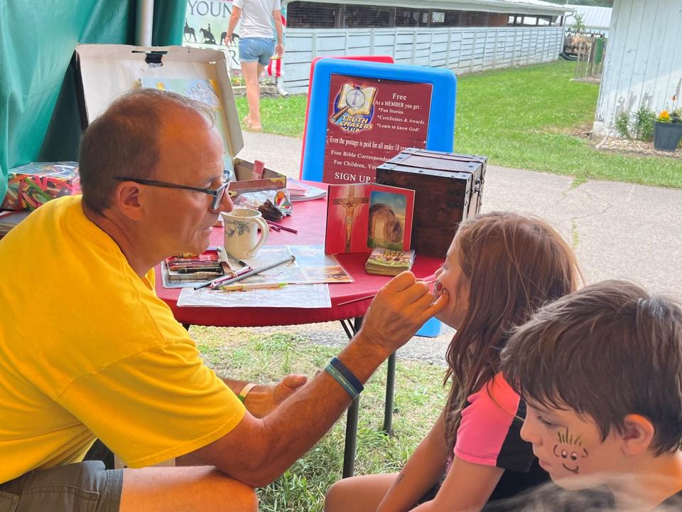 Penny and Benjamin McNutt came to the Crawford County Fair last year with their mom, Denise McNutt, and enjoyed having their faces painted by Dale Baer of Child Evangelical Fellowship. The fair this year is July 15-20.