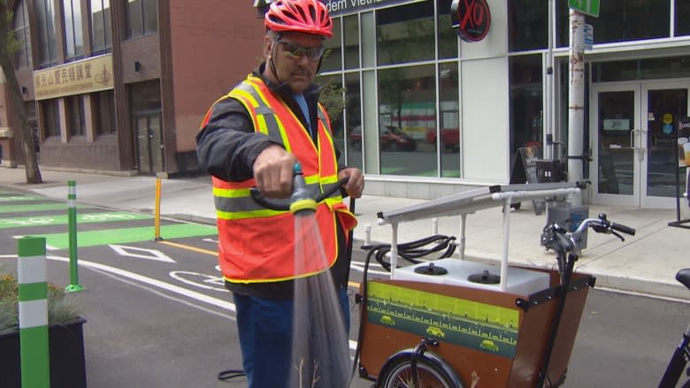 Solar-powered trikes watering plants along Edmonton's downtown bike lanes