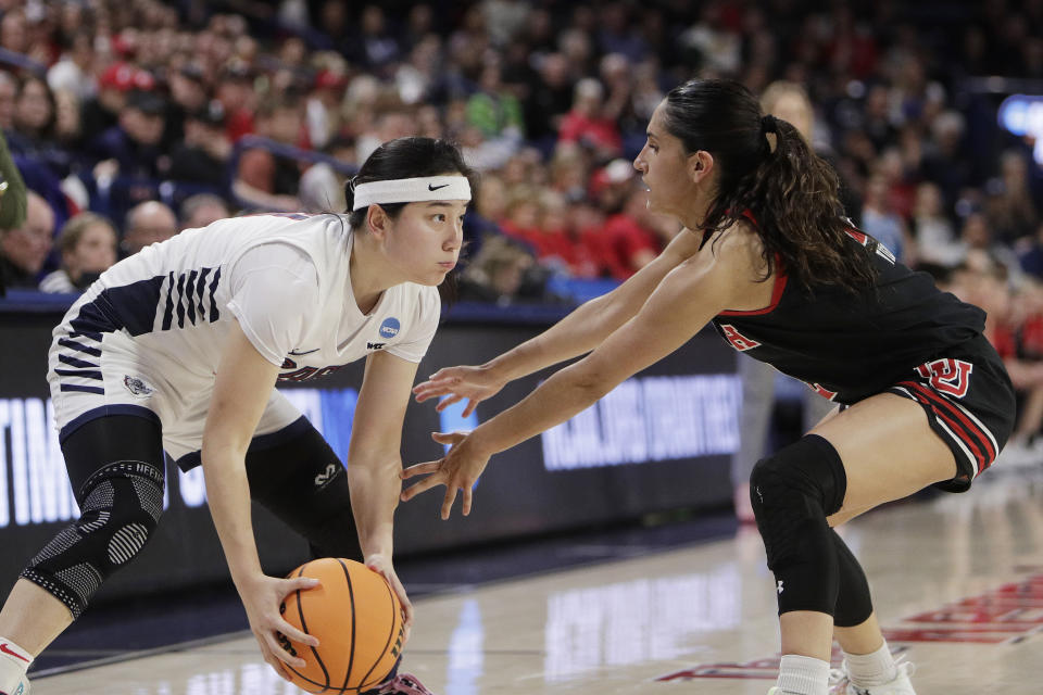 Gonzaga guard Kaylynne Truong, left, controls the ball while pressured by Utah guard Ines Vieira during the second half of a second-round college basketball game in the NCAA Tournament in Spokane, Wash., Monday, March 25, 2024. (AP Photo/Young Kwak)