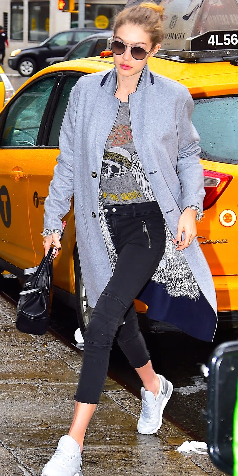 <p>Hadid doubled up on her layers for a chilly N.Y.C. day, wearing a long gray coat (get a similar one from <a rel="nofollow noopener" href="http://click.linksynergy.com/fs-bin/click?id=93xLBvPhAeE&subid=0&offerid=463275.1&type=10&tmpid=8157&RD_PARM1=http%253A%252F%252Fshop.nordstrom.com%252Fs%252Ftopshop-snap-button-three-quarter-coat%252F4490589%253Forigin%253Dcategory-personalizedsort%2526fashioncolor%253DGREY&u1=ISNewsGigiHStreetStyle1.24JA" target="_blank" data-ylk="slk:Topshop;elm:context_link;itc:0;sec:content-canvas" class="link ">Topshop</a>) over a fuzzy gray cardigan from B Collection by Bobeau ($158; <a rel="nofollow noopener" href="http://click.linksynergy.com/fs-bin/click?id=93xLBvPhAeE&subid=0&offerid=465536.1&type=10&tmpid=2425&RD_PARM1=http%3A%2F%2Fwww1.bloomingdales.com%2Fshop%2Fproduct%2Fb-collection-by-bobeau-harper-eyelash-knit-cardigan%3FID%3D1865195%2526CategoryID%3D2910%2526linkModule%3D1&u1=ISNewsGigiHadidStreetStyle1.27JA" target="_blank" data-ylk="slk:bloomingdales.com;elm:context_link;itc:0;sec:content-canvas" class="link ">bloomingdales.com</a>), a vintage Lauren Moshi rocker tee, moto-style dark wash DL1961 jeans ($136; <a rel="nofollow noopener" href="https://infinitycreativeagency-dot-yamm-track.appspot.com/Redirect?ukey=10uYjtY5hQ8sg9tZZeBordG-NGcuebIs33C7rnbW8vsY-0&key=YAMMID-01566650&link=http%3A%2F%2Fwww.revolve.com%2Fdl1961-x-jessica-alba-no-4-instasculpt-crop-moto-in-mirage%2Fdp%2FDL19-WJ271%2F%3Fd%3DF%26currency%3DUSD%26source%3Dgoogle%26mkwid%3D%257Bifsearch%3As%257D%257Bifcontent%3Ac%257D_dc%257Cpcrid%257C114237079571%257Cpkw%257C%257Cpmt%257C%26pdv%3Dc%26matchtype%3D%26gclid%3DCK6l3PT129ECFQ9EfgodMIcN0g" target="_blank" data-ylk="slk:revolve.com;elm:context_link;itc:0;sec:content-canvas" class="link ">revolve.com</a>), and white sneakers. The model accessorized with round sunglasses and a structured black purse. </p>