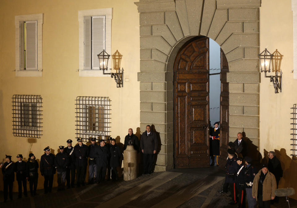 FILE - Vatican Swiss guards close the main door of the papal villa in Castel Gandolfo, south of Rome, Feb. 28, 2013, after Benedict XVI greeted the faithful for the last time as pope on Thursday. Pope Emeritus Benedict XVI's death has hit Castel Gandolfo's "castellani" particularly hard, since many knew him personally, and in some ways had already bid him an emotional farewell when he uttered his final words as pope from the palace balcony overlooking the town square. (AP Photo/Alessandra Tarantino, File)