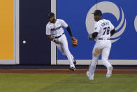 Miami Marlins right fielders Bryan De La Cruz and Jesus Sanchez (76) miss the ball hit by Washington Nationals' Lane Thomas during the eighth inning of a baseball game, Wednesday, Sept. 22, 2021, in Miami. (AP Photo/Marta Lavandier)
