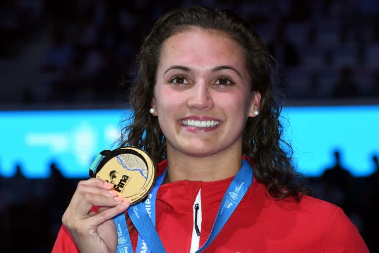 Canada's Kylie Masse celebrates on the podium after the women's 100m backstroke final on July 25, 2017