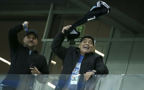 Diego Maradona twirls Messi jersey around his head - Credit: GETTY IMAGES