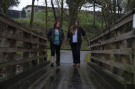 Grants Pass Mayor Sara Bristol walks with Cassandra Williams in Tussing Park, Friday, March 22, 2024, in Grants Pass, Ore. Bristol, who works at Rogue Community College, met Williams, who is homeless, at the school, and came to talk to her while she was visiting the park. (AP Photo/Jenny Kane)