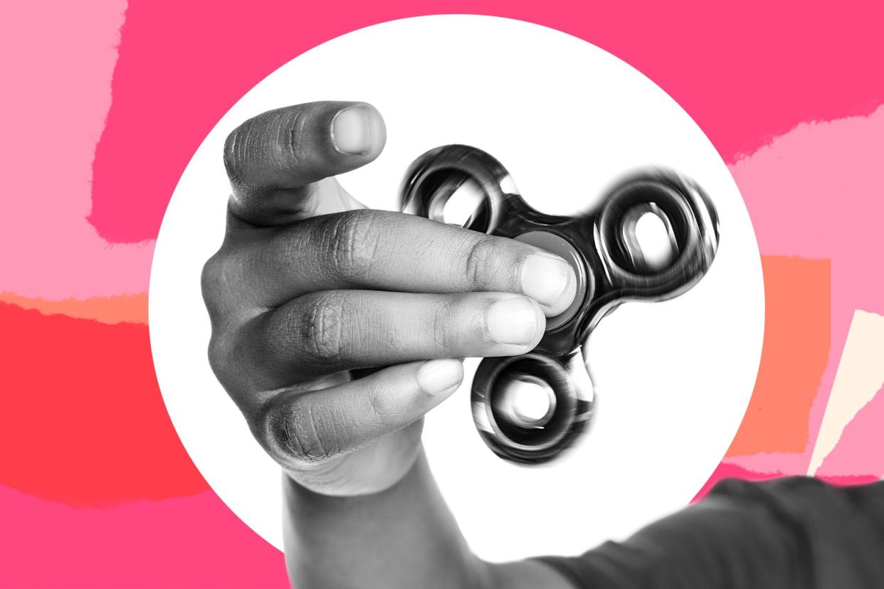 A child holds a fidget spinner in their hand.