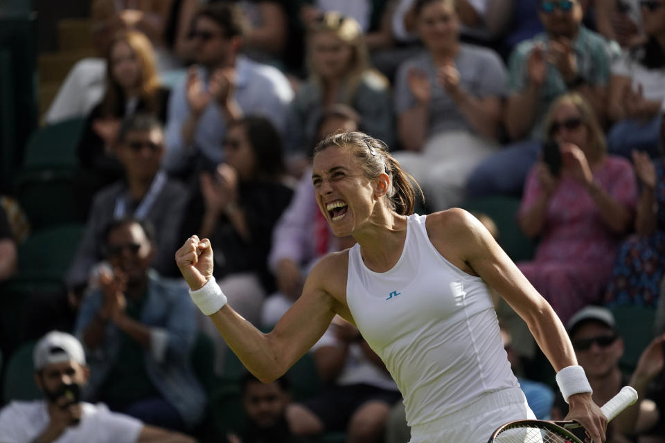 Croatia's Petra Martic celebrates winning against Jessica Pegula of the US during their women's third round singles match on day six of the Wimbledon tennis championships in London, Saturday, July 2, 2022. (AP Photo/Alberto Pezzali)