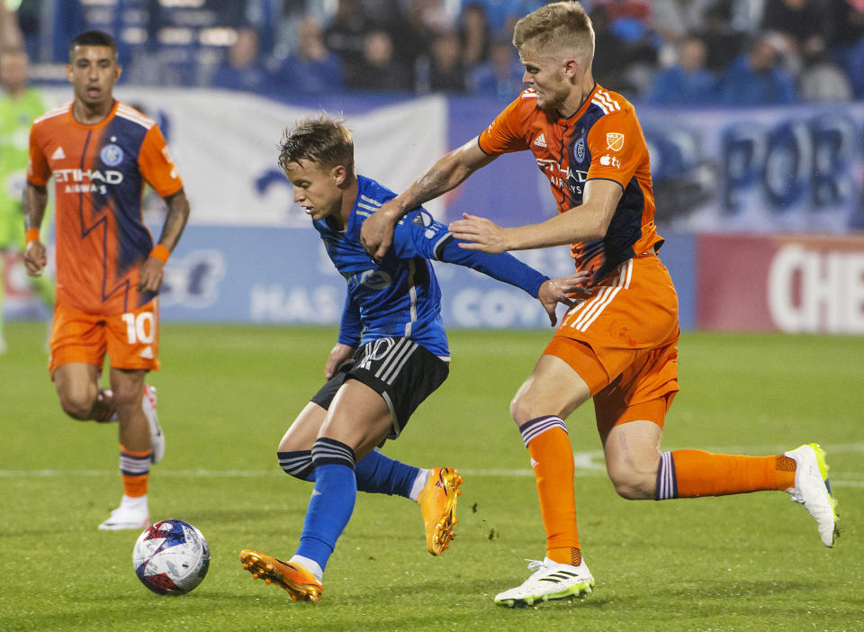 CF Montreal's Bryce Duke, center, tries to keep the ball away from New York City FC's Keaton Parks during the first half of an MLS soccer match Saturday, July 1, 2023, in Montreal. (Peter McCabe/The Canadian Press via AP)