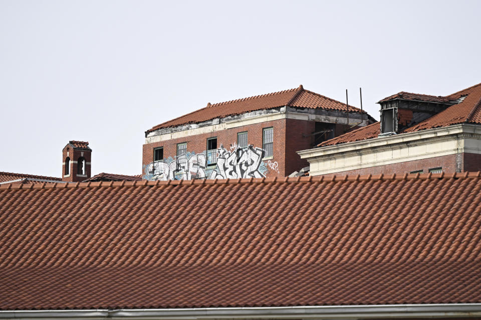 Graffiti is seen atop of a building on the campus of St. Elizabeth near the Entertainment and Sports Arena, Friday, March 1, 2024, in Washington. The proposed move of the Capitals and Wizards sports teams to nearby Virginia has stoked concern in a pair of fragile Washington neighborhoods. (AP Photo/Terrance Williams)