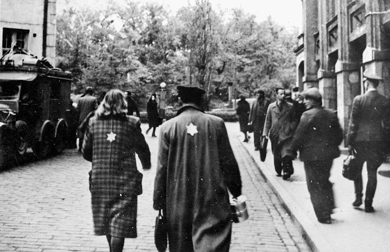 The Nazis made the yellow badge infamous around the world, but its roots are much older. <a href="https://www.gettyimages.com/detail/news-photo/jews-wearing-the-yellow-badge-news-photo/92425374?phrase=jewish%20badge&adppopup=true" rel="nofollow noopener" target="_blank" data-ylk="slk:Roger Viollet/Getty Images;elm:context_link;itc:0;sec:content-canvas" class="link ">Roger Viollet/Getty Images</a>