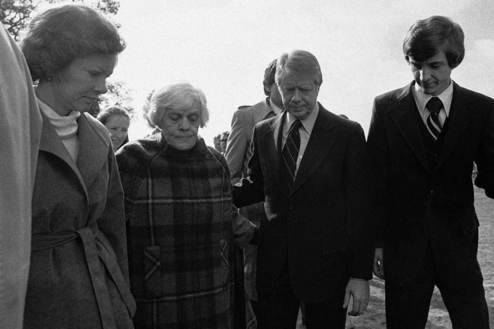 President Jimmy Carter assists his mother Miss Lillian Carter accompanied by his wife, Rosalynn, left, as they enter the Maranatha Baptist Church near Plains, Ga., on Jan. 21, 1978 for the funeral of the president's uncle, Alton Carter. (AP Photo/Joe Holloway Jr.)