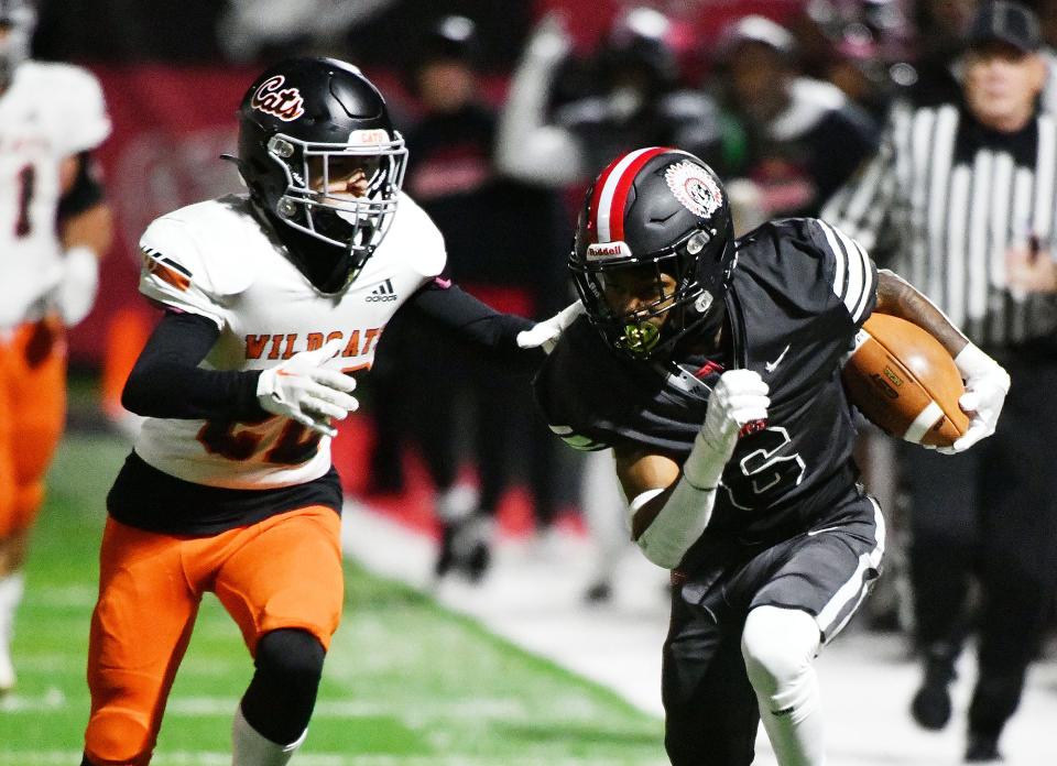 Aliquippa’s John Tracy carries picks up some yards during Friday’s Class 4A WPIAL quarterfinal playoff game against Latrobe at Aliquippa High School.