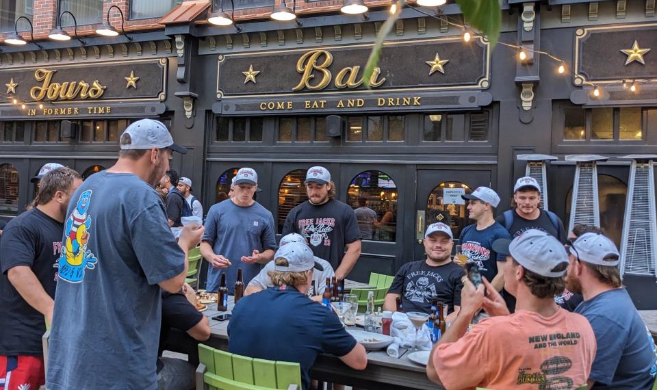 Members of the New England Free Jacks celebrate their championship victory with a meal at The Fours in Quincy's Kilroy Square.