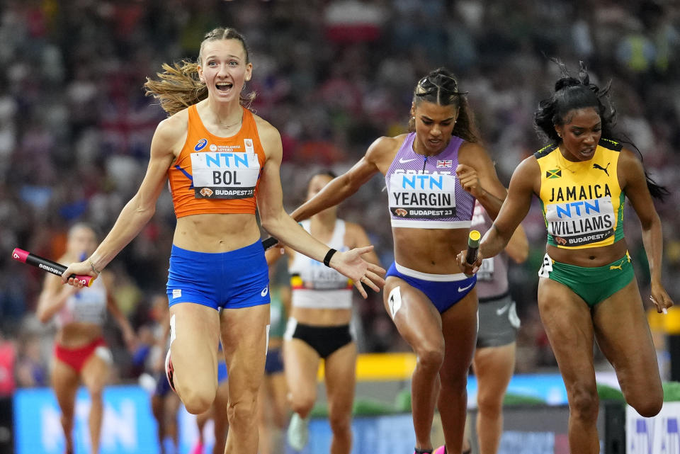 Femke Bol, of the Netherlands crosses the line ahead of Stacey Ann Williams, of Jamaica and Nicole Yeargin, of Great Britain to win the final of the Women's 4x400-meters relay during the World Athletics Championships in Budapest, Hungary, Sunday, Aug. 27, 2023. (AP Photo/Petr David Josek)