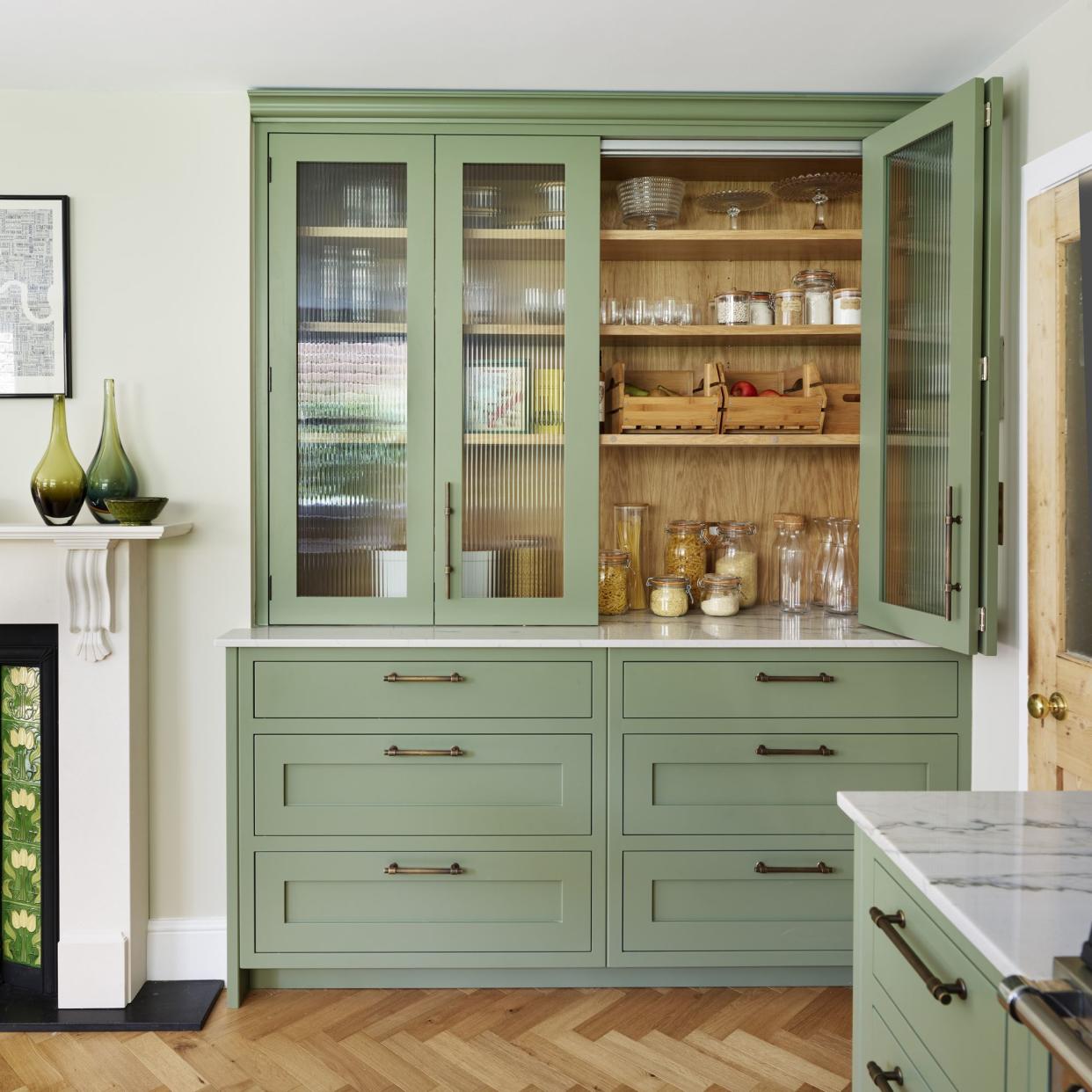  Light and bright kitchen with wood panelled island and patterned marble splashbacks. 