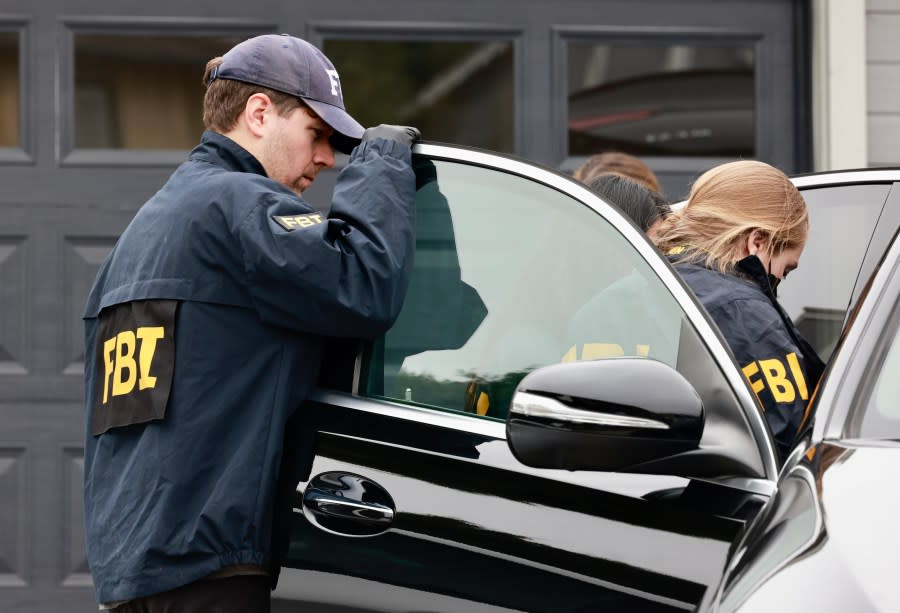 FBI agents search vehicles in Oakland on June 20, 2024 while the mayor’s home was being raided by additional agents. (Photo by Jessica Christian/San Francisco Chronicle via Getty Images)