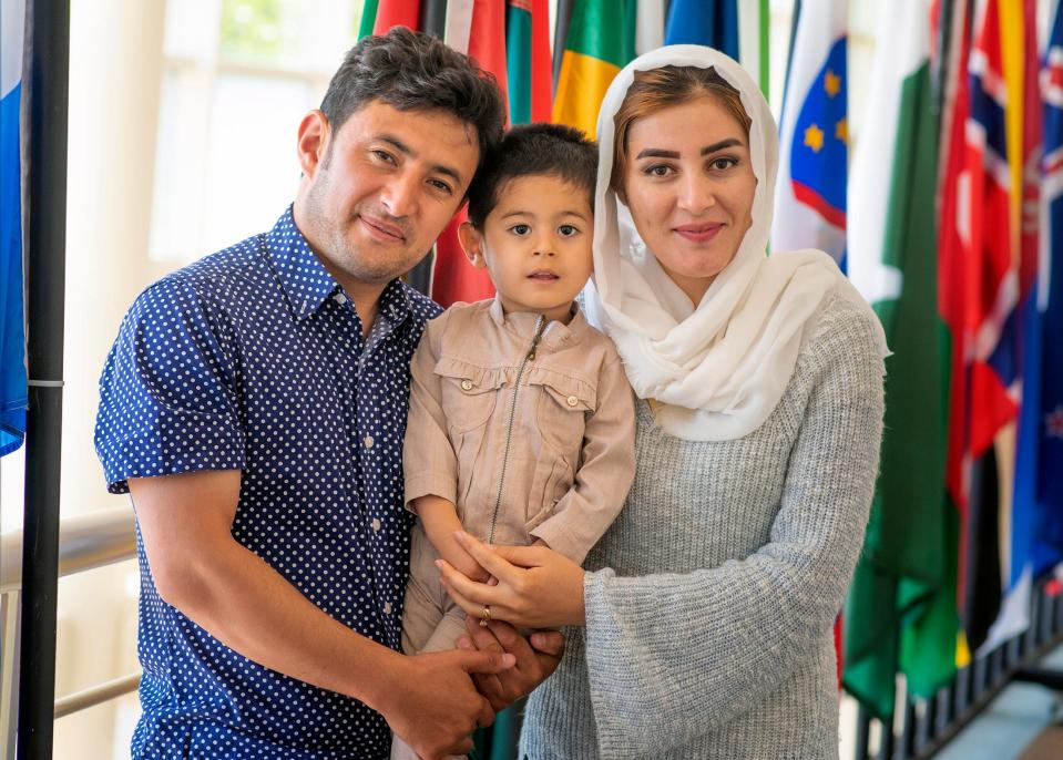 Husband and wife, Sayed Noor Hassan Nasery and Aziza Kermani, pose for a photo with their son at Oklahoma State University in Stillwater.