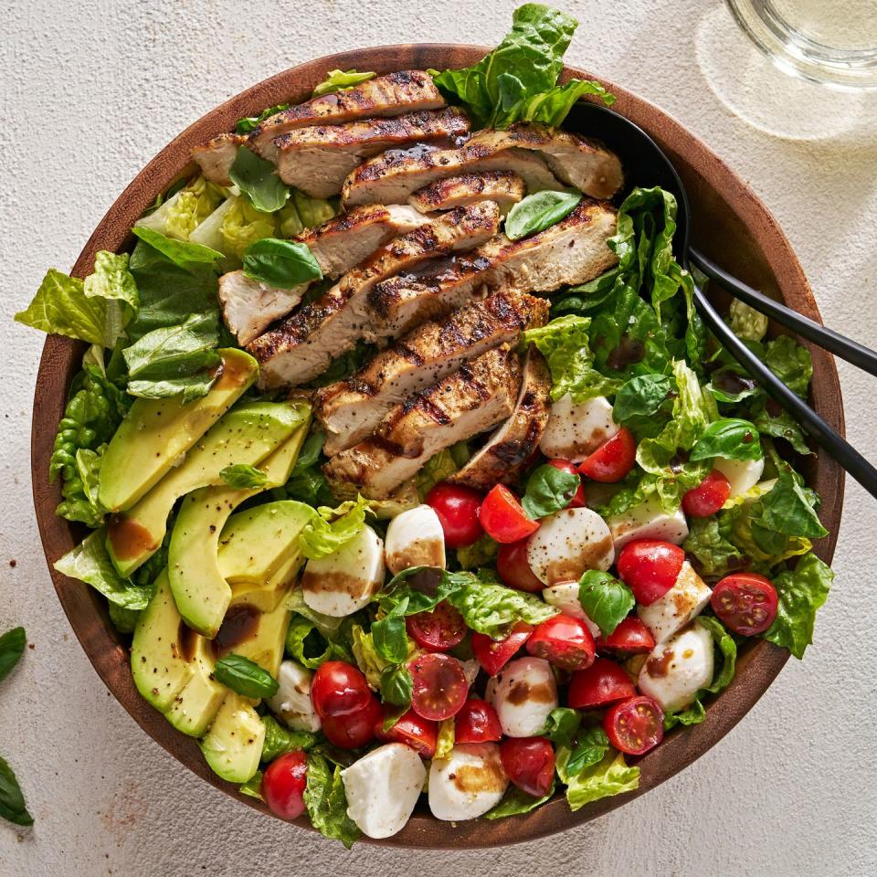 chicken avocado caprese salad in a bowl with balsamic dressing