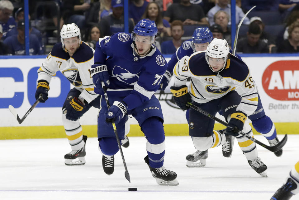 Tampa Bay Lightning center Anthony Cirelli (71) breaks out ahead of Buffalo Sabres left wing C.J. Smith (49) and center Vladimir Sobotka (17), of the Czech Republic, during the second period of an NHL hockey game Thursday, Feb. 21, 2019, in Tampa, Fla. (AP Photo/Chris O'Meara)