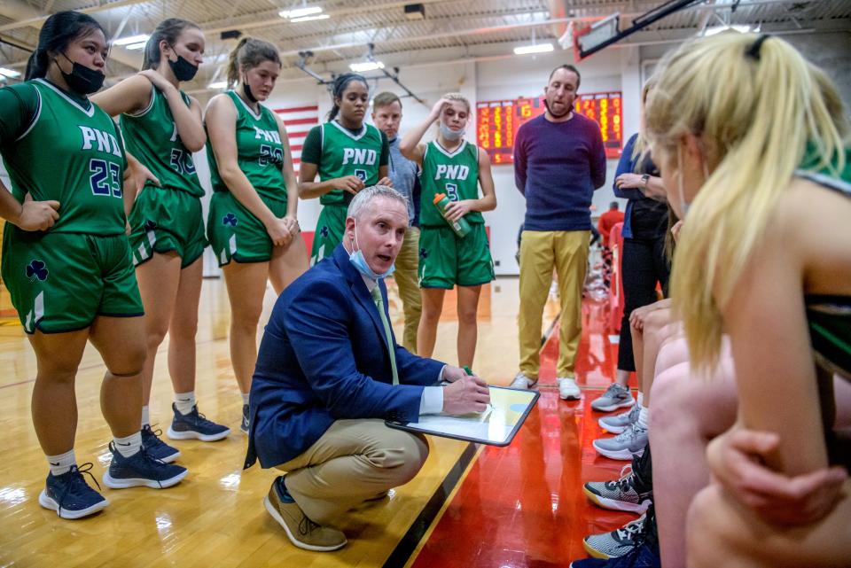 Peoria Notre Dame head coach Layne Langholf, shown taking to his team during a 46-45 win over Metamora on Dec. 7, is a former player on Winnebago's 1992 state-ranked boys team and will lead the Irish, ranked No. 6 in Class 3A, against Winnebago's No. 1-ranked and undefeated team in Class 2A Saturday afternoon at Winnebago.