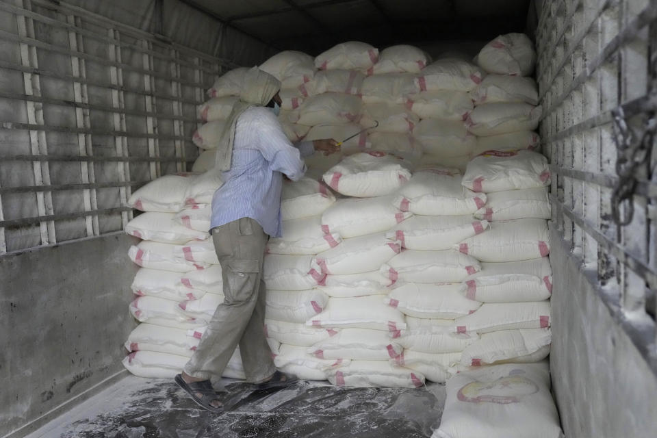 A worker loads bags of flour into a truck at Modern Mills of Lebanon, in Beirut, Lebanon, April 12, 2022. The World Bank approved a $150 million loan for food security in crisis-hit Lebanon to stabilize bread prices for the next six months, the economy minister said Monday. (AP Photo/Hussein Malla)