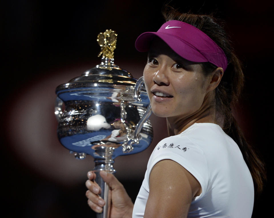 FILE - In this Jan. 25, 2014, file photo, Li Na, of China, holds the Daphne Akhurst Memorial Trophy after defeating Dominika Cibulkova of Slovakia in their women's singles final at the Australian Open tennis championship in Melbourne, Australia. (AP Photo/Andrew Brownbill, File)