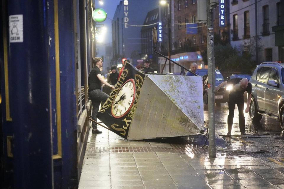 A clock tower falls to the ground in Eyre Square, Galway, during Storm Isha. (PA)