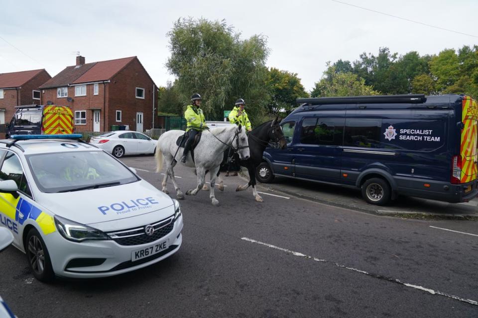 Mounted police patrol the area close to the scene on Aycliffe Crescent, Gateshead, where a 14-year-old boy was fatally attacked (PA)