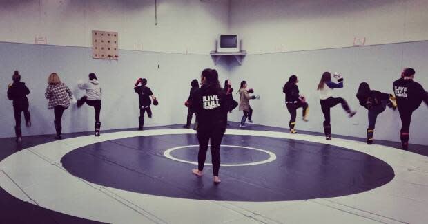 Melissa Moses (middle) is pictured instructing her students in martial arts at her studio, Nicola Valley Muay Thai and Self Defence. (Melissa Moses/Facebook - image credit)