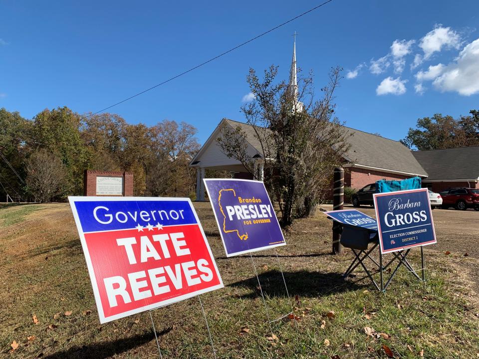 Campaign signs for gubernatorial candidates Tate Reeves and Brandon Presley and District 2 Election Commissioner candidate Barbara Gross sit outside China Grove Church in Madison on Nov. 7.