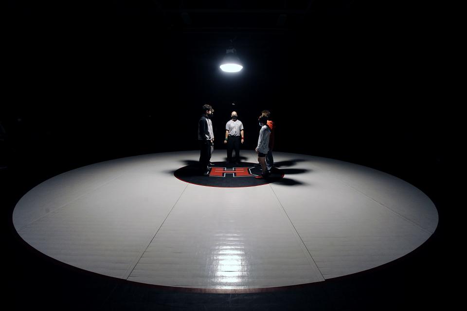 Bellingham and Holliston High School wrestling captains at the coin toss at Holliston High School, Jan. 26, 2022.